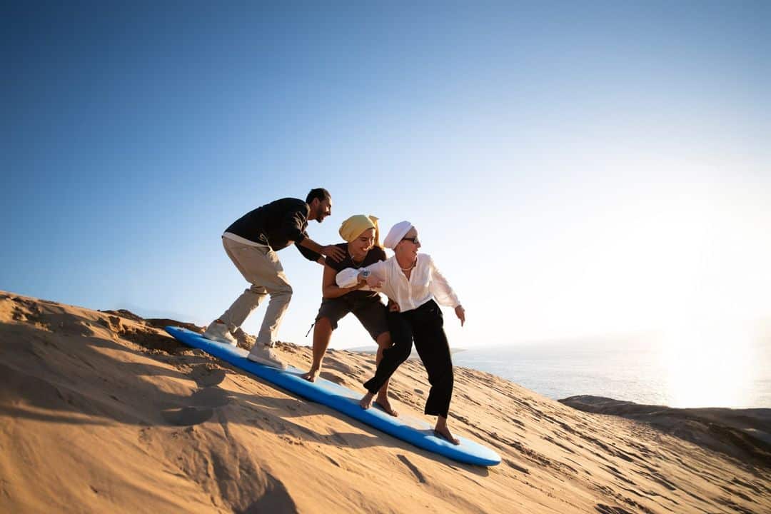 Sandboarding in the desert with panoramic sunset view - Sandboard & Sunset Quest