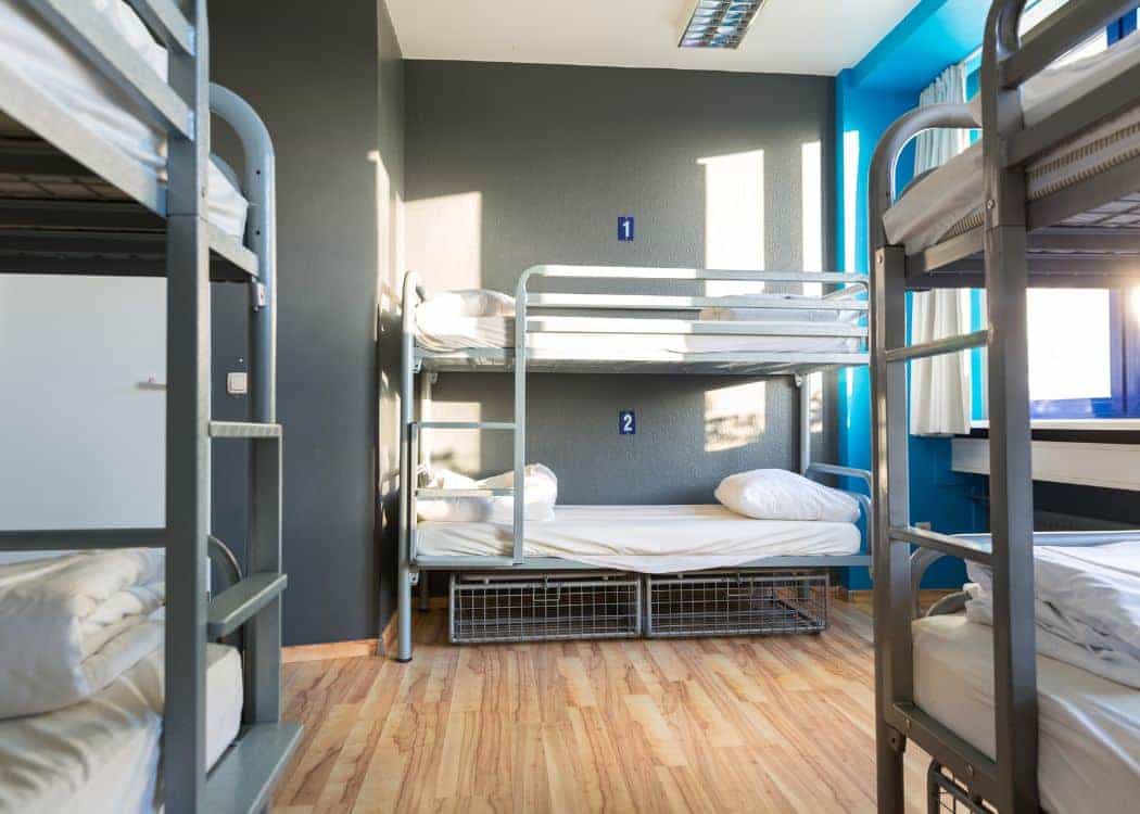 Cozy Dorm Room with bunk beds and a social atmosphere in Taghazout's hostel.